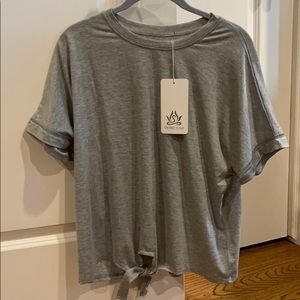 Cute grey loose tee with tie at bottom.